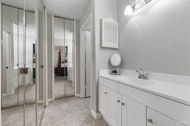 a bedroom with two bed and a chandelier