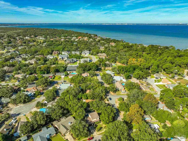 a view of a house with yard and sitting area
