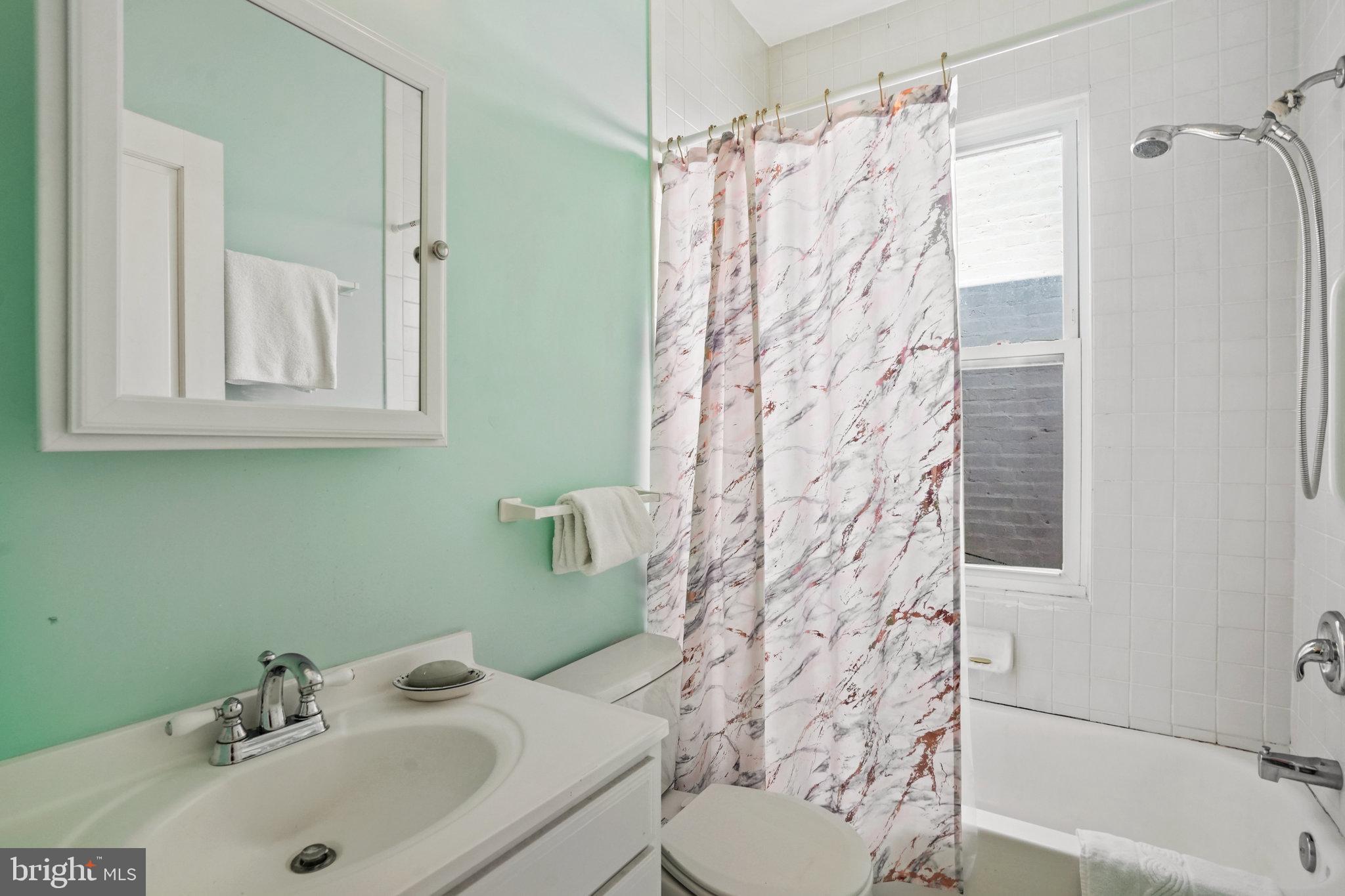 628 A Street Northeast Washington, DC 20002 - Photo 20 of 29 a bathroom with a sink toilet and shower