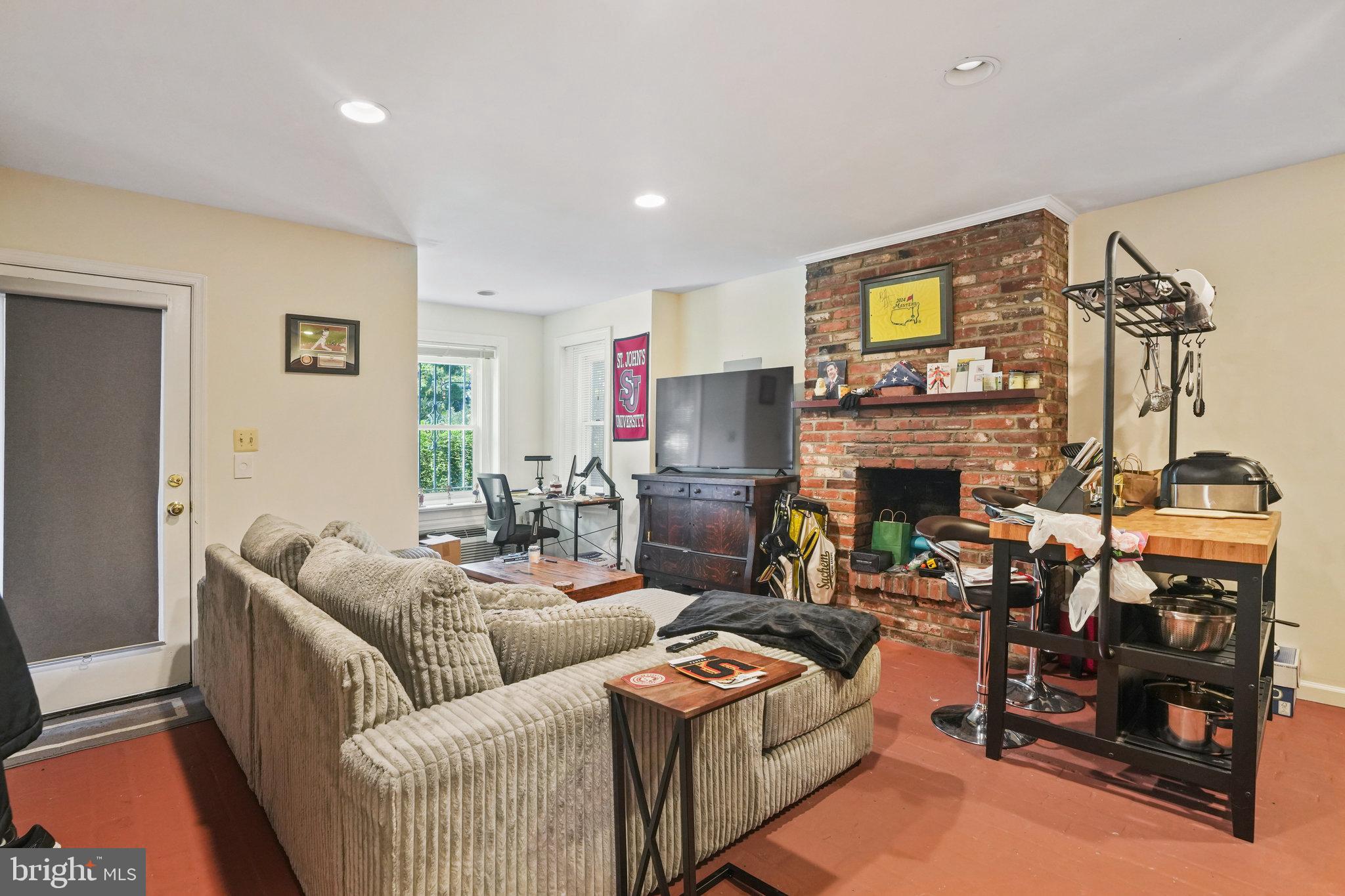 628 A Street Northeast Washington, DC 20002 - Photo 21 of 29 a living room with furniture a fireplace and a flat screen tv