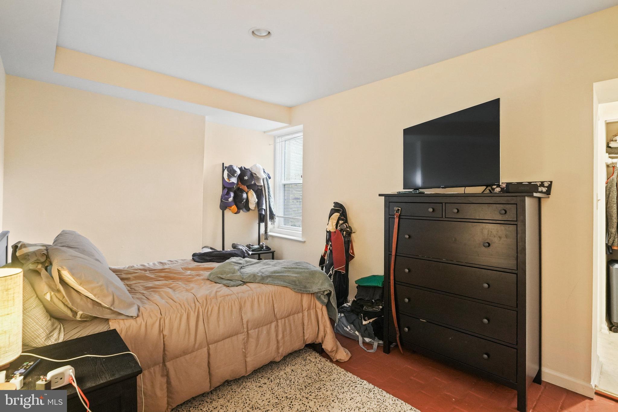 628 A Street Northeast Washington, DC 20002 - Photo 23 of 29 a bedroom with a bed and a flat tv screen on wall
