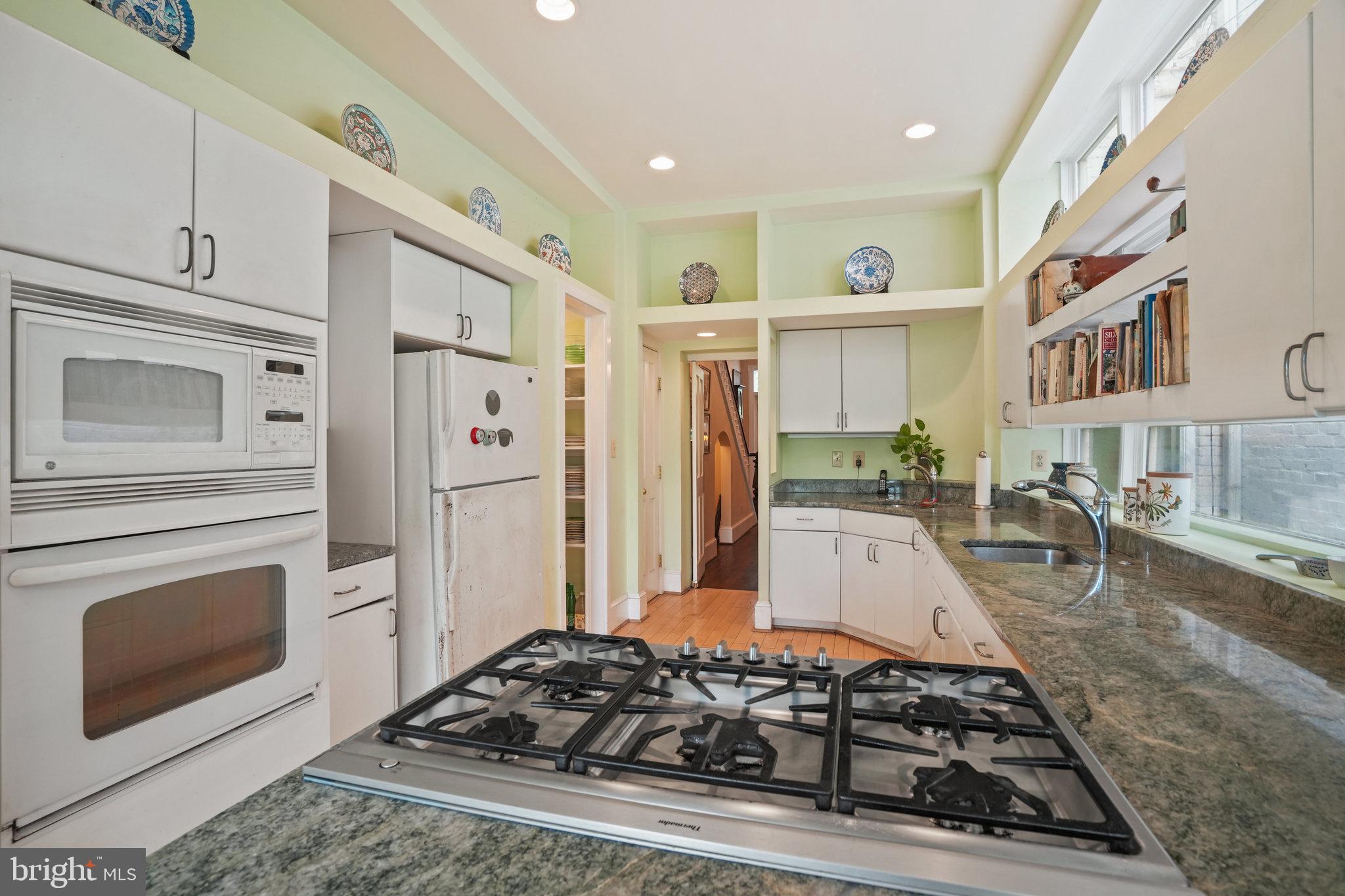 628 A Street Northeast Washington, DC 20002 - Photo 8 of 29 a kitchen with stainless steel appliances granite countertop a stove and a refrigerator