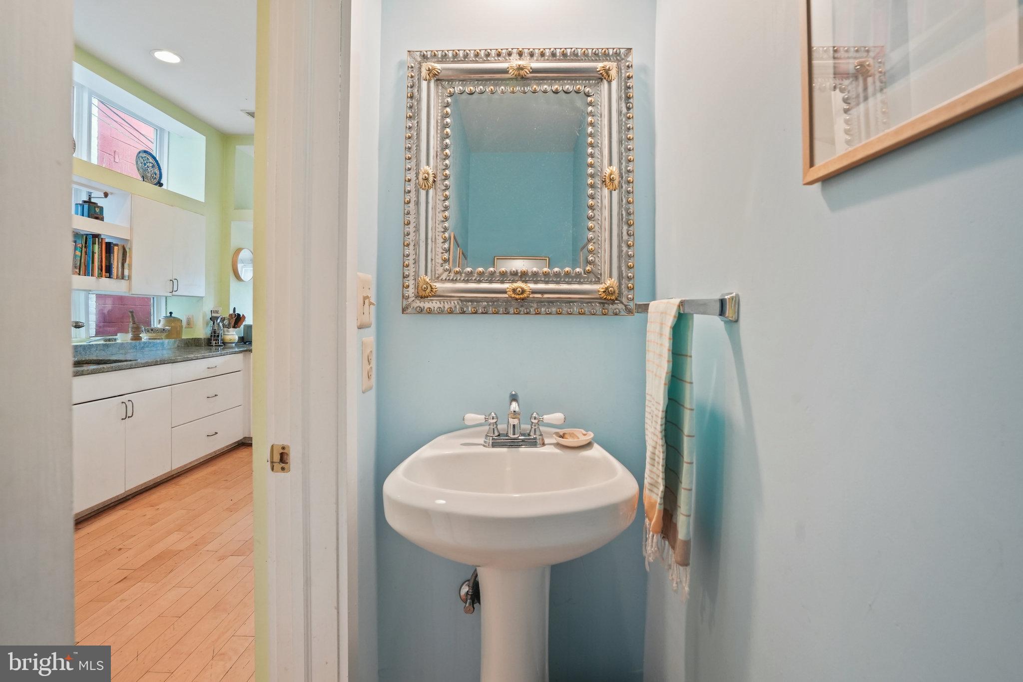 628 A Street Northeast Washington, DC 20002 - Photo 9 of 29 a bathroom with a sink and a mirror