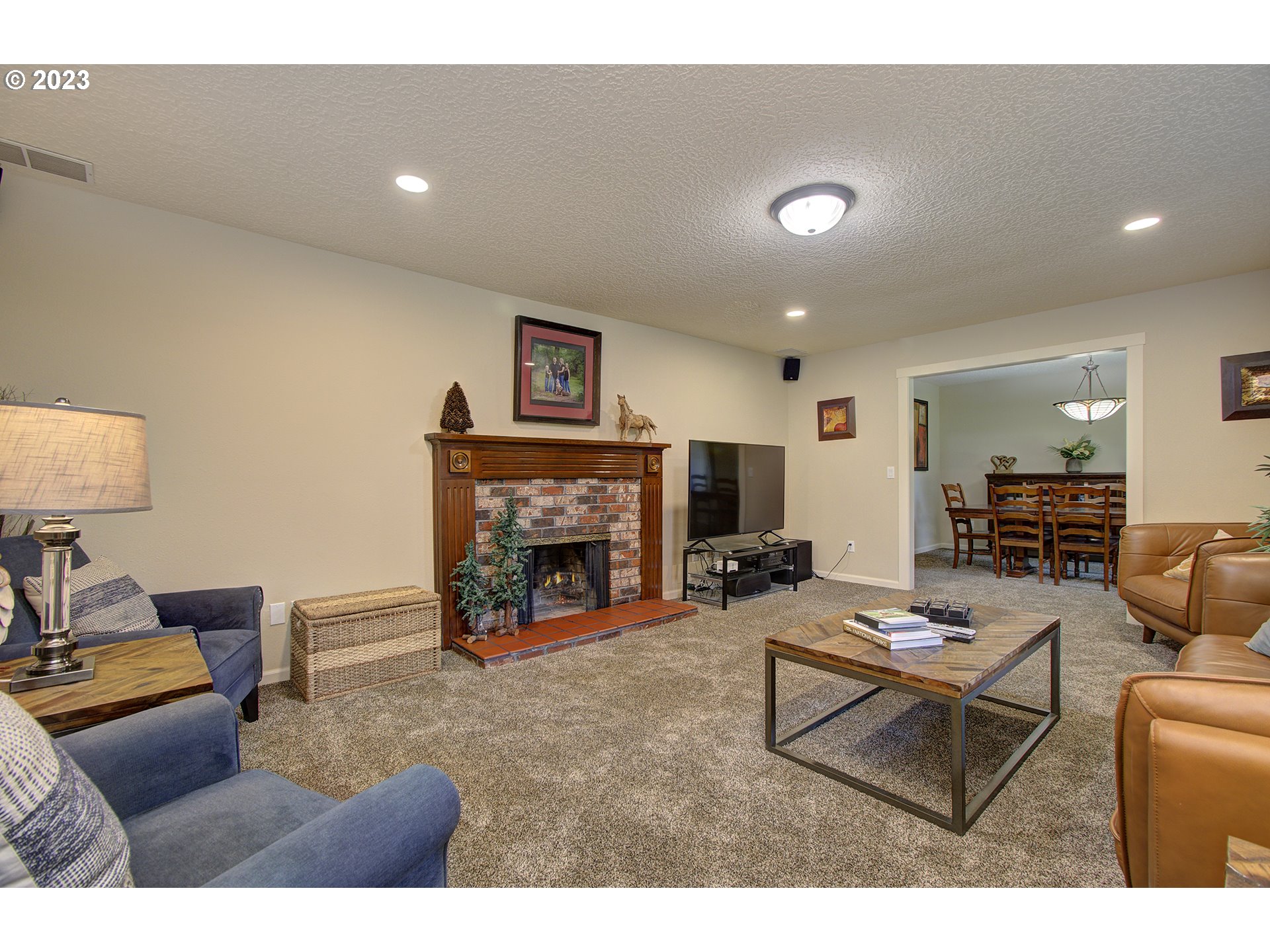 13025 Northeast Prairie Road Brush Prairie, WA 98606 - Photo 11 of 47 a living room with furniture and a fireplace