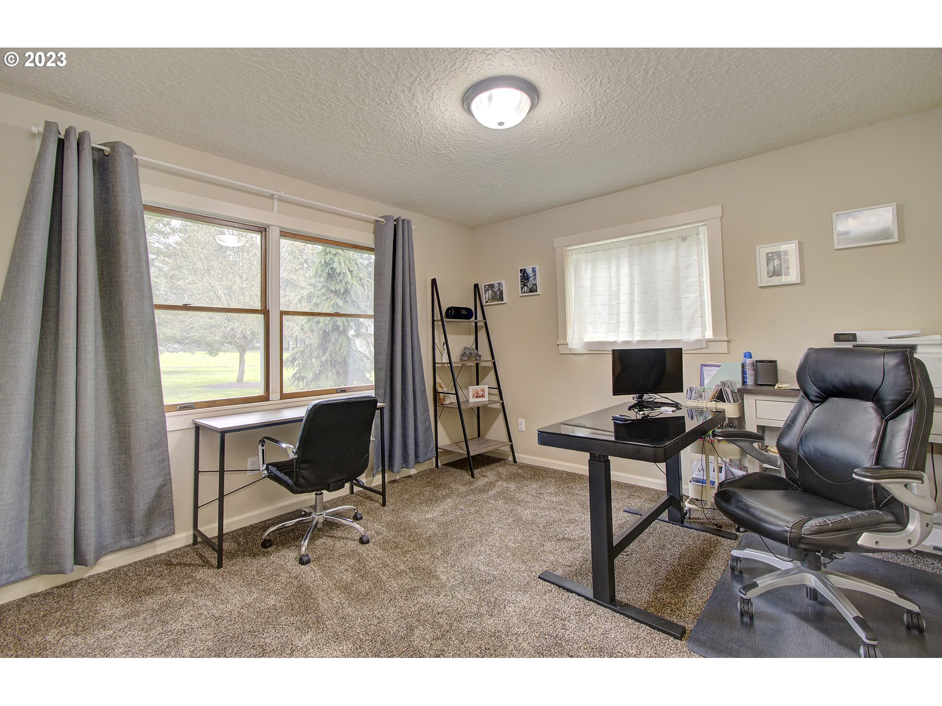 13025 Northeast Prairie Road Brush Prairie, WA 98606 - Photo 13 of 47 a living room with furniture a large window and a flat screen tv