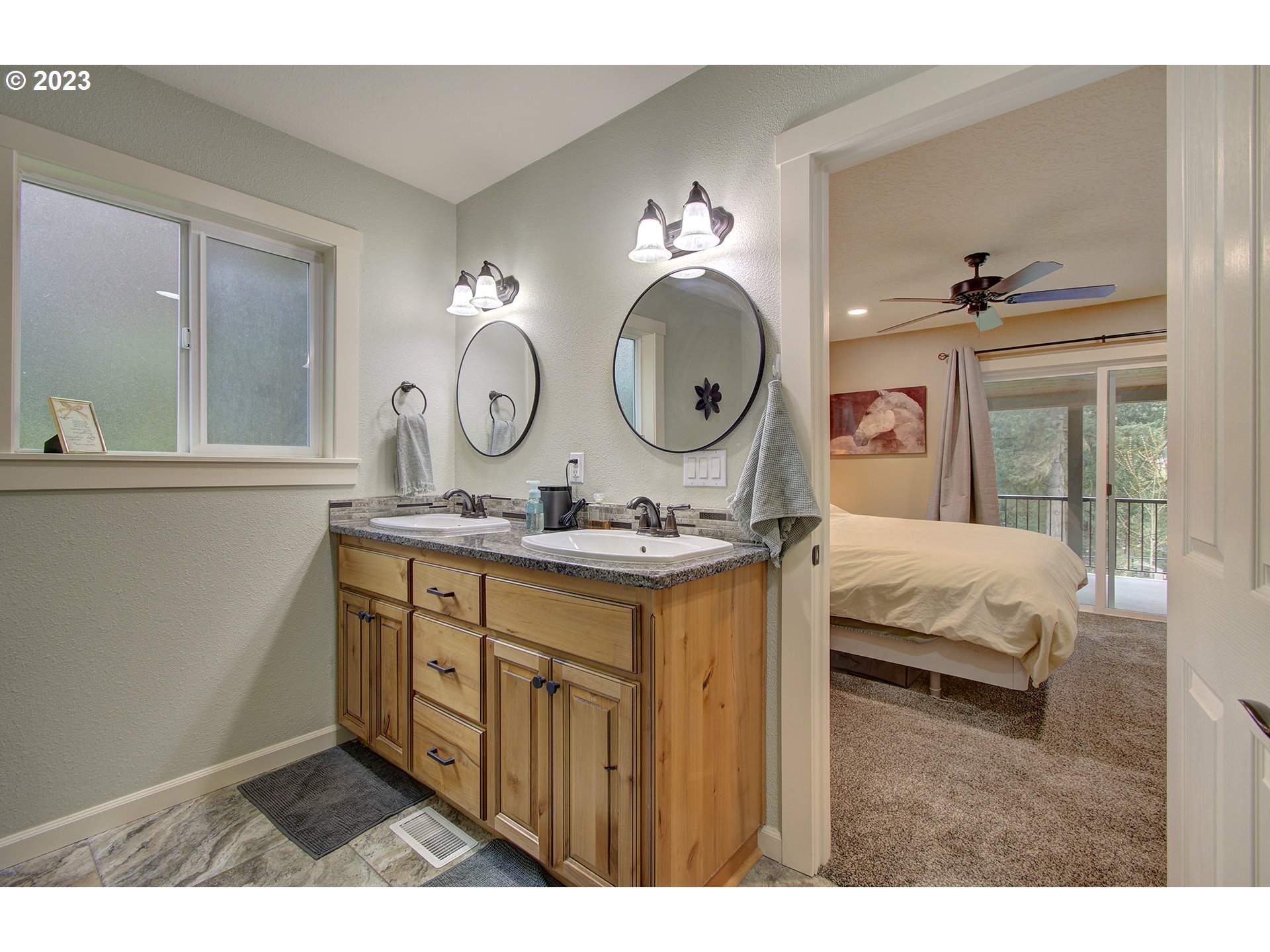 13025 Northeast Prairie Road Brush Prairie, WA 98606 - Photo 21 of 47 a en suite bathroom with a double vanity sink and a mirror