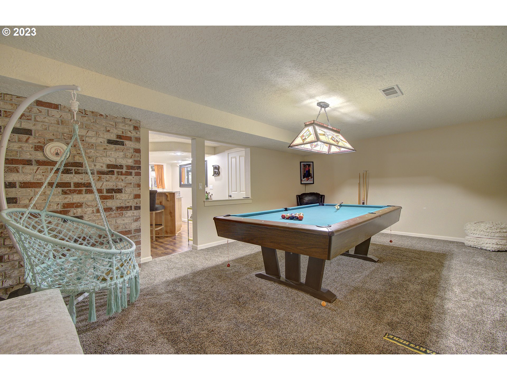 13025 Northeast Prairie Road Brush Prairie, WA 98606 - Photo 27 of 47 a living room with furniture and a chandelier