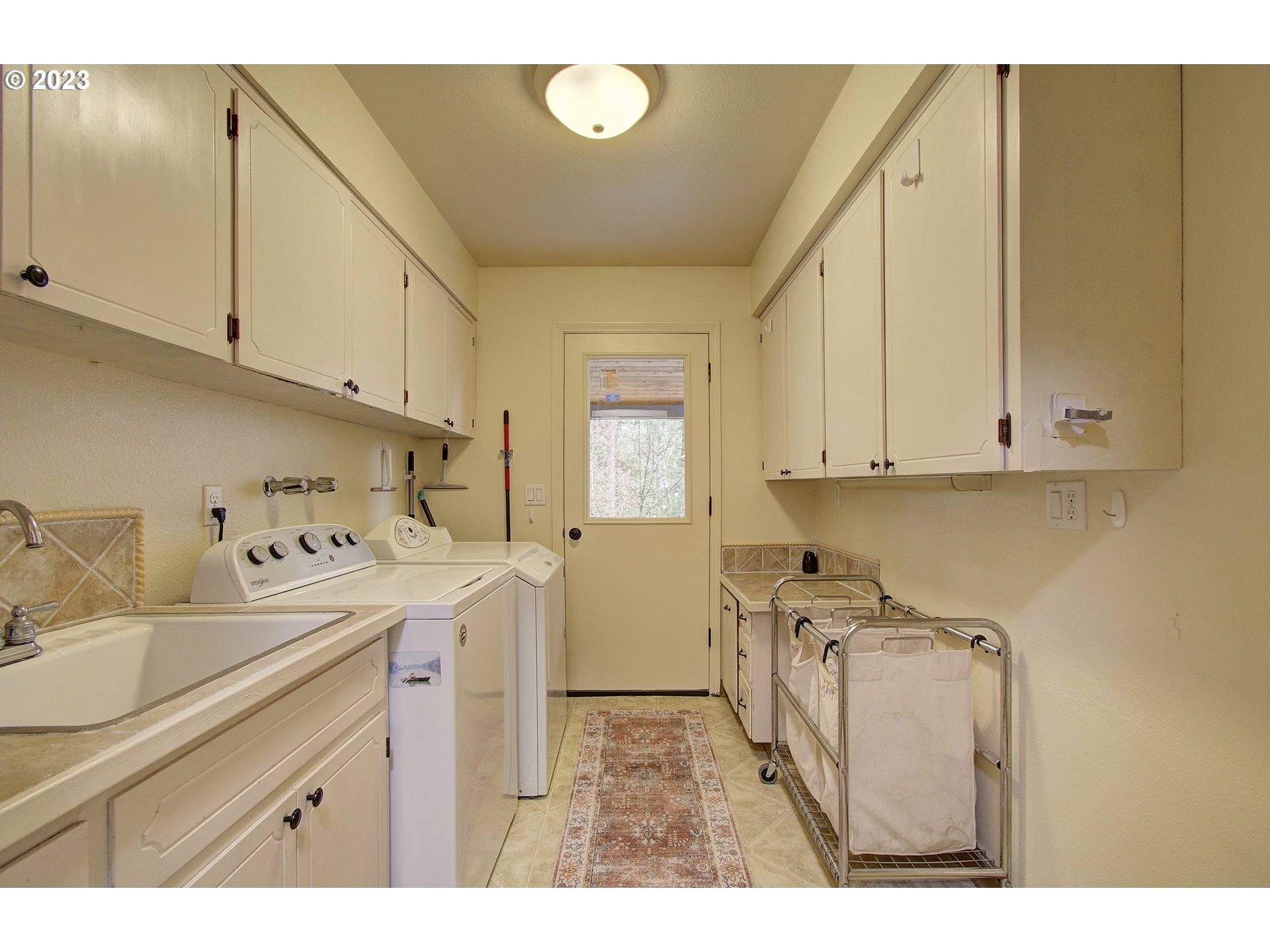 13025 Northeast Prairie Road Brush Prairie, WA 98606 - Photo 39 of 47 a utility room with cabinets washer and dryer