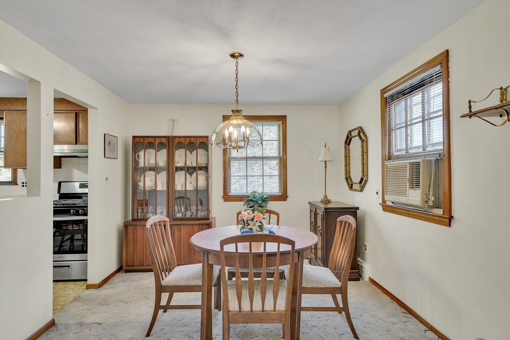 42 Grapevine Avenue Lexington, MA 02421 - Photo 12 of 36 a dining room with furniture a chandelier and window