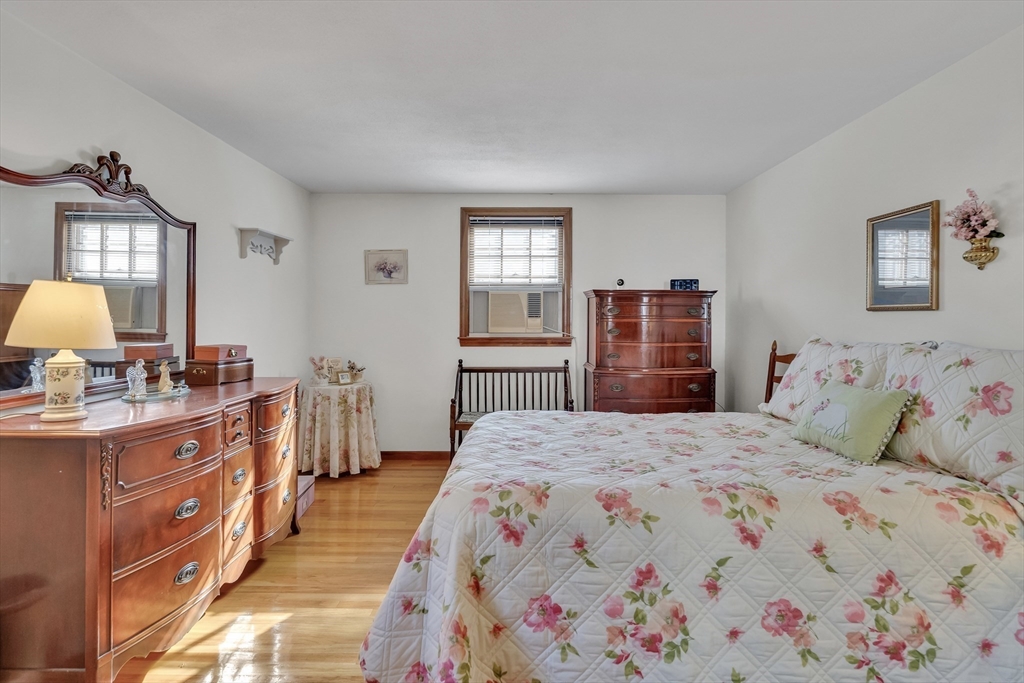 42 Grapevine Avenue Lexington, MA 02421 - Photo 17 of 36 a bedroom with a bed and dresser with mirror