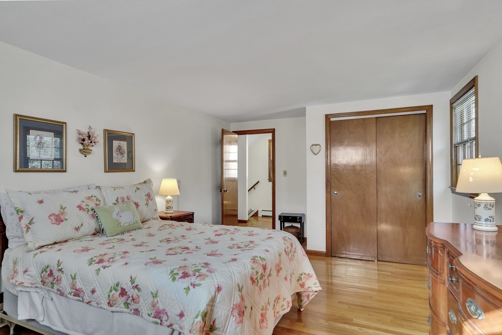 42 Grapevine Avenue Lexington, MA 02421 - Photo 19 of 36 a bedroom with a bed and a lamp on dresser
