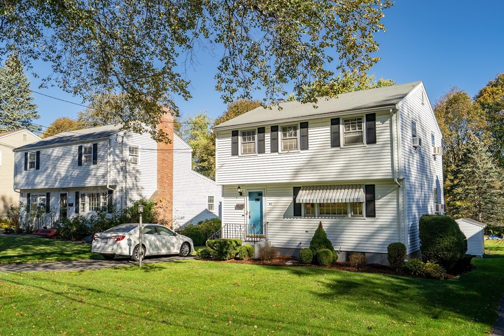 42 Grapevine Avenue Lexington, MA 02421 - Photo 2 of 36 a front view of a house with a yard and garage