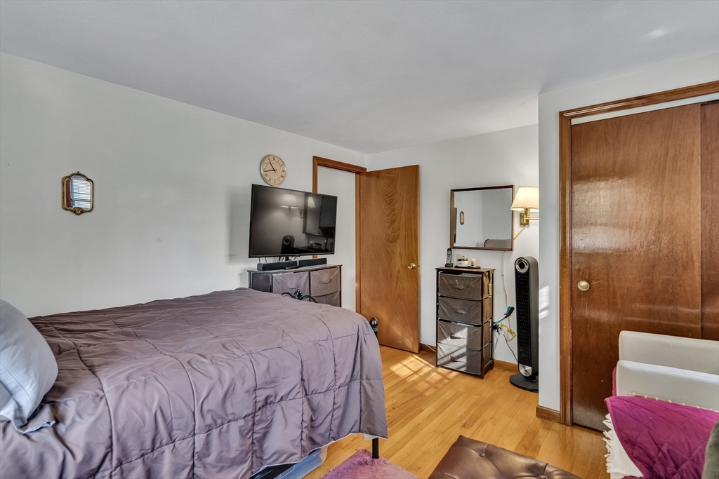 42 Grapevine Avenue Lexington, MA 02421 - Photo 22 of 36 a bedroom with a bed and a television in it