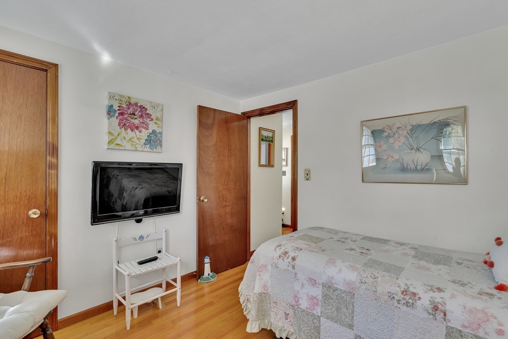 42 Grapevine Avenue Lexington, MA 02421 - Photo 24 of 36 a bedroom with a bed and a flat screen tv