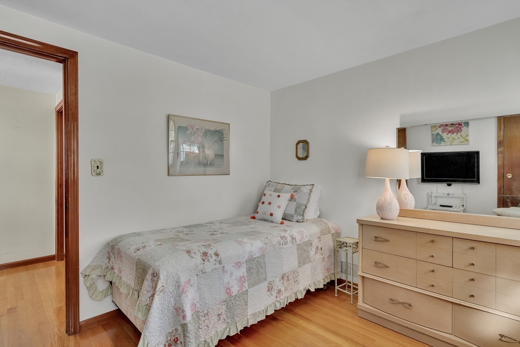 42 Grapevine Avenue Lexington, MA 02421 - Photo 25 of 36 a bedroom with a bed and a flat tv screen on dresser
