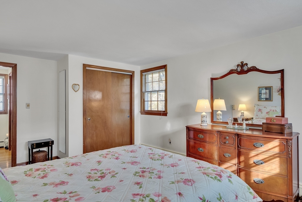 42 Grapevine Avenue Lexington, MA 02421 - Photo 26 of 36 a bedroom with a bed and a dresser with mirror