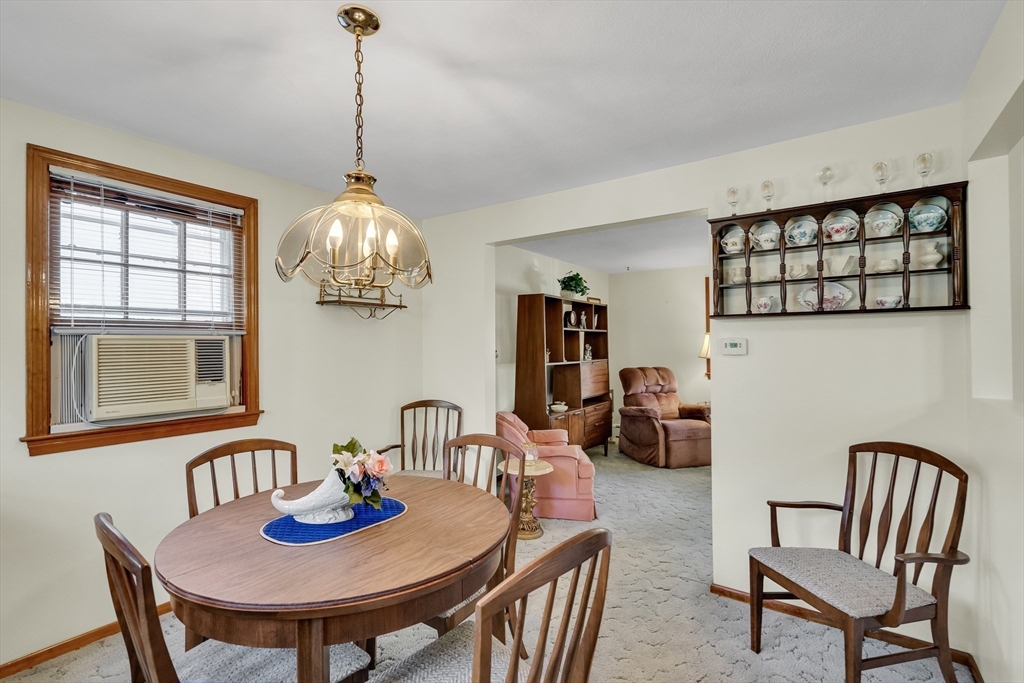 42 Grapevine Avenue Lexington, MA 02421 - Photo 9 of 36 a dining room with furniture a window and a chandelier