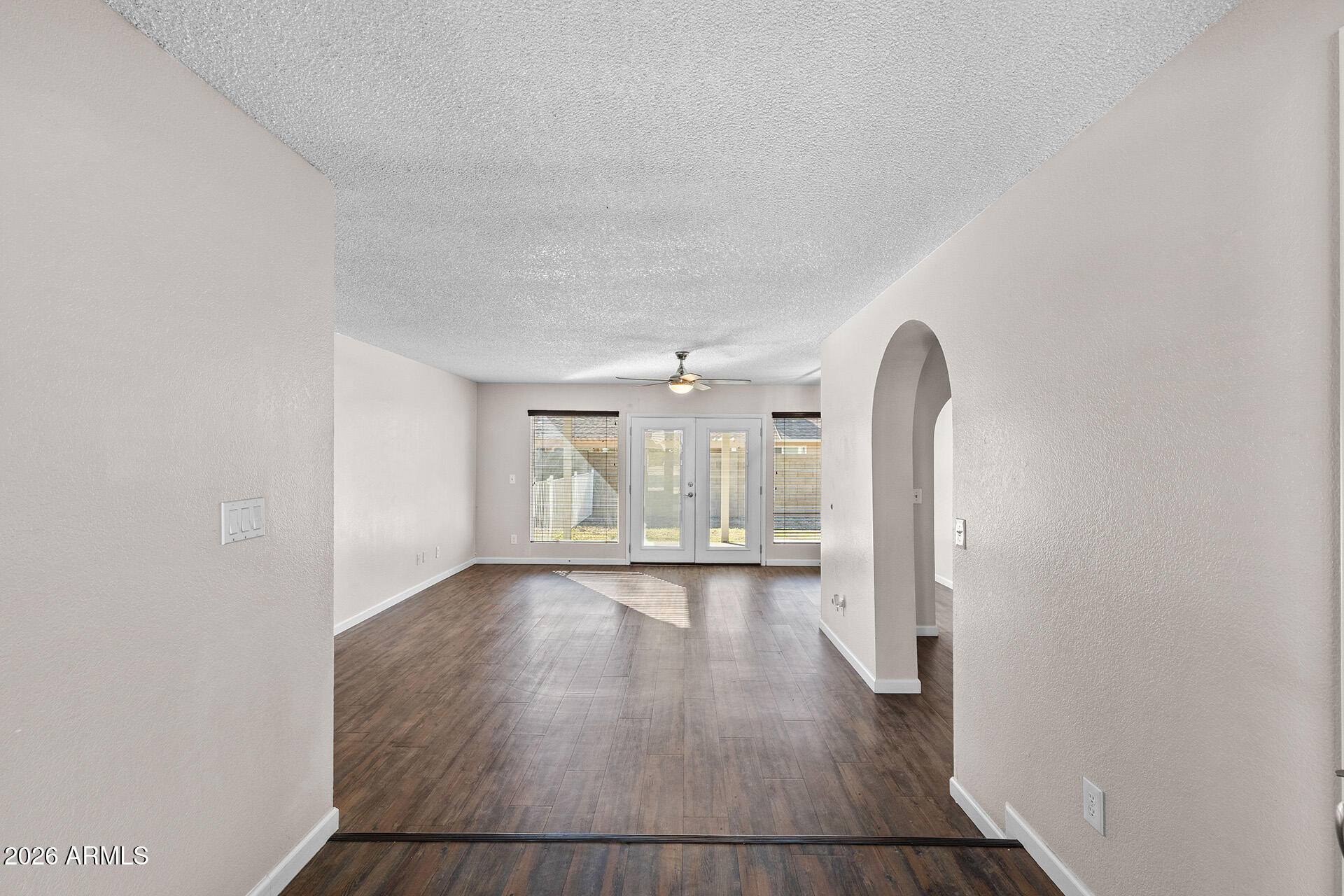 7267 West Charter Oak Road Peoria, AZ 85381 - Photo 13 of 45 an empty room with wooden floor and windows