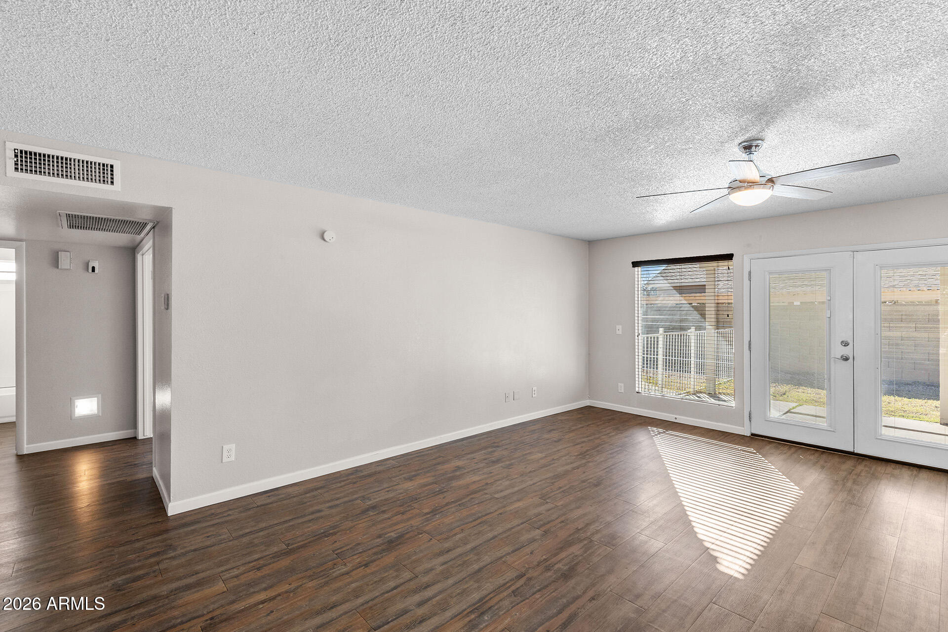 7267 West Charter Oak Road Peoria, AZ 85381 - Photo 14 of 45 a view of an empty room with window and wooden floor