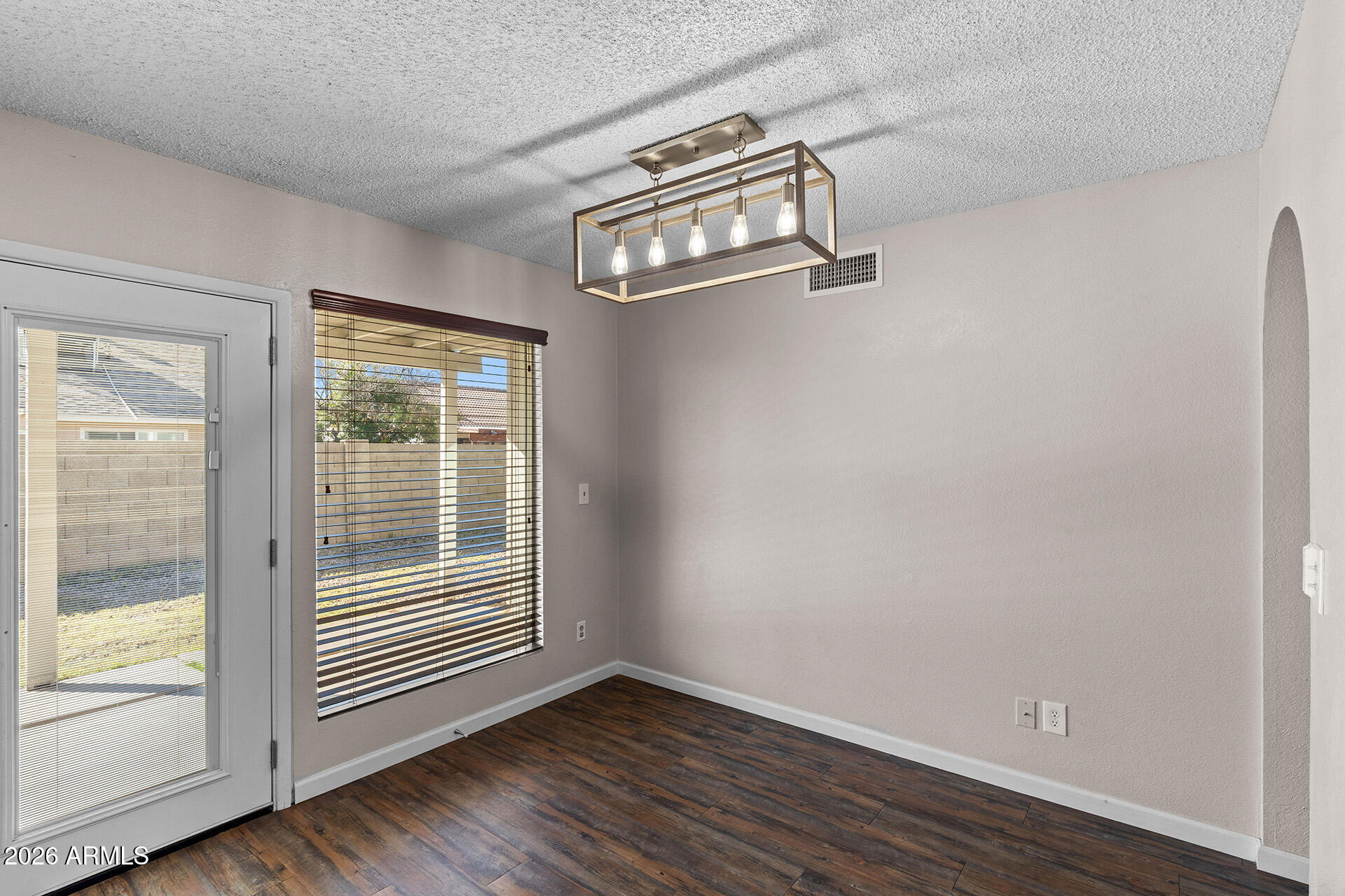 7267 West Charter Oak Road Peoria, AZ 85381 - Photo 16 of 45 a view of an empty room with wooden floor and a window