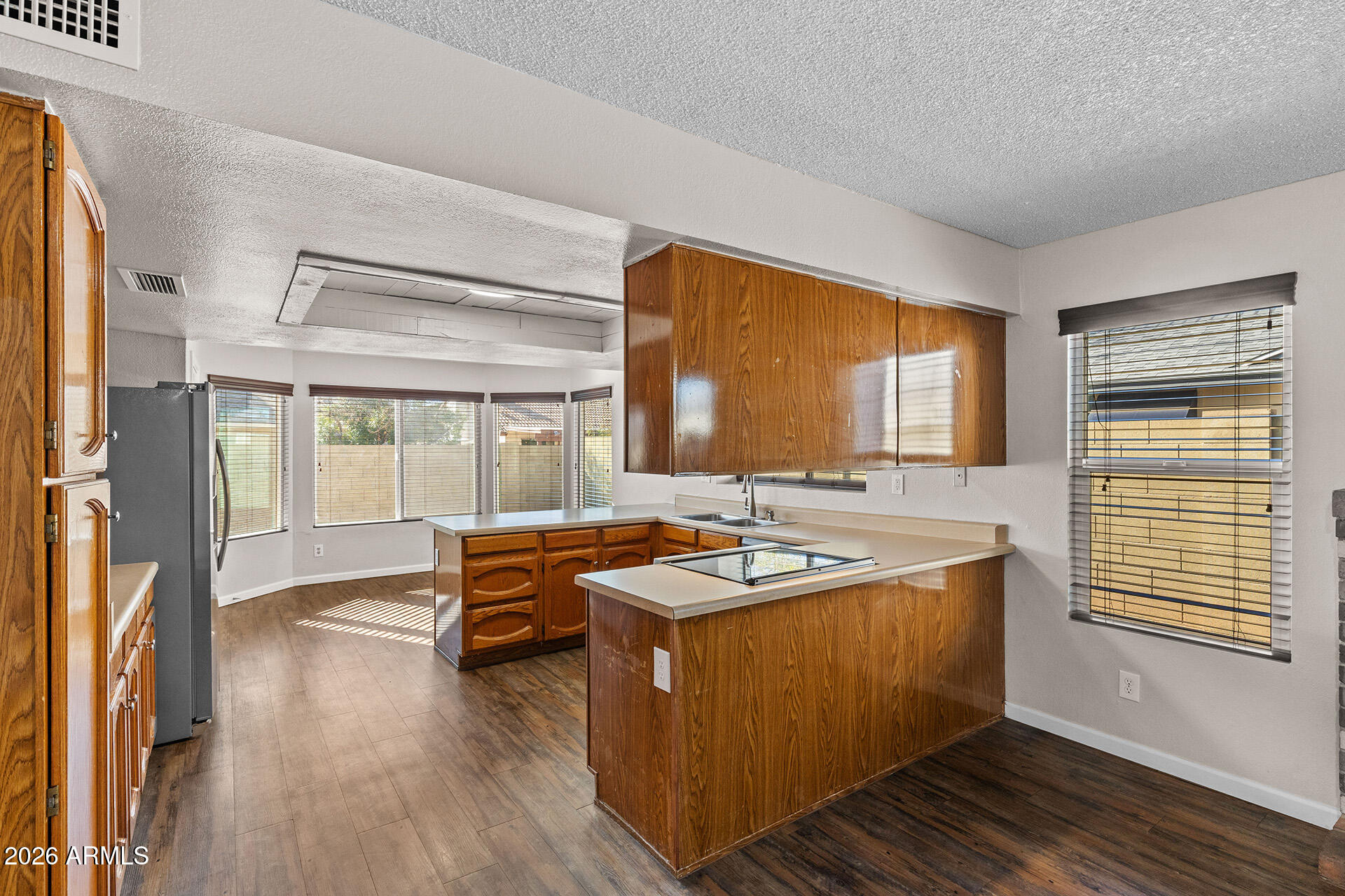 7267 West Charter Oak Road Peoria, AZ 85381 - Photo 19 of 45 a living room with stainless steel appliances granite countertop furniture sink and wooden floor