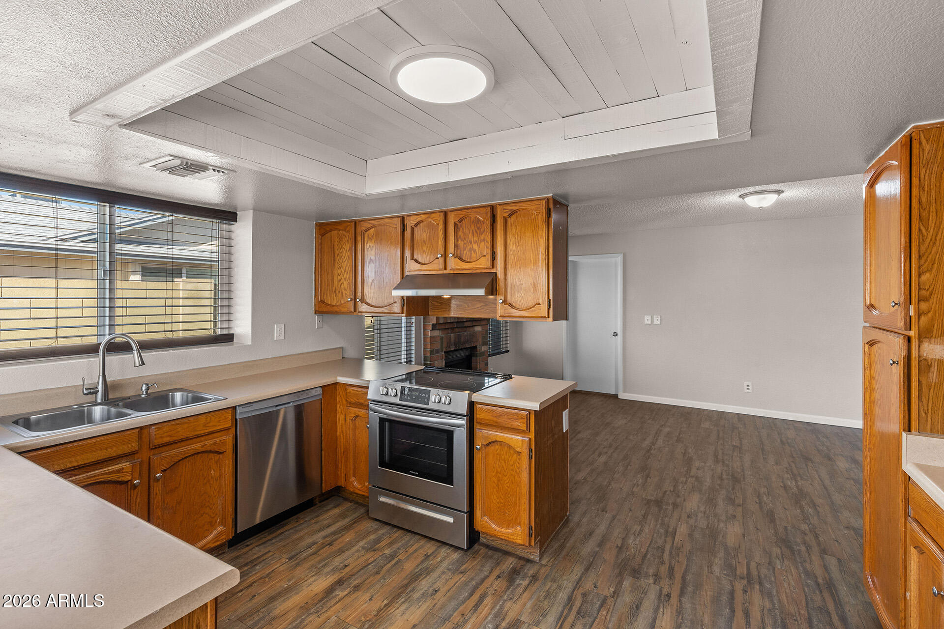 7267 West Charter Oak Road Peoria, AZ 85381 - Photo 21 of 45 a kitchen with a sink stove and cabinets