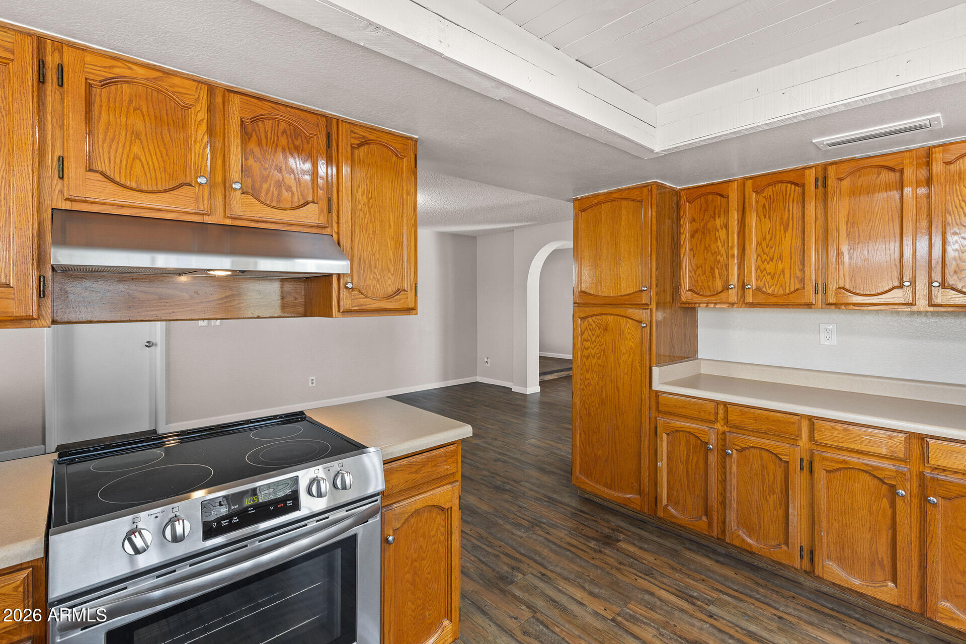 7267 West Charter Oak Road Peoria, AZ 85381 - Photo 23 of 45 a kitchen with a stove and a refrigerator