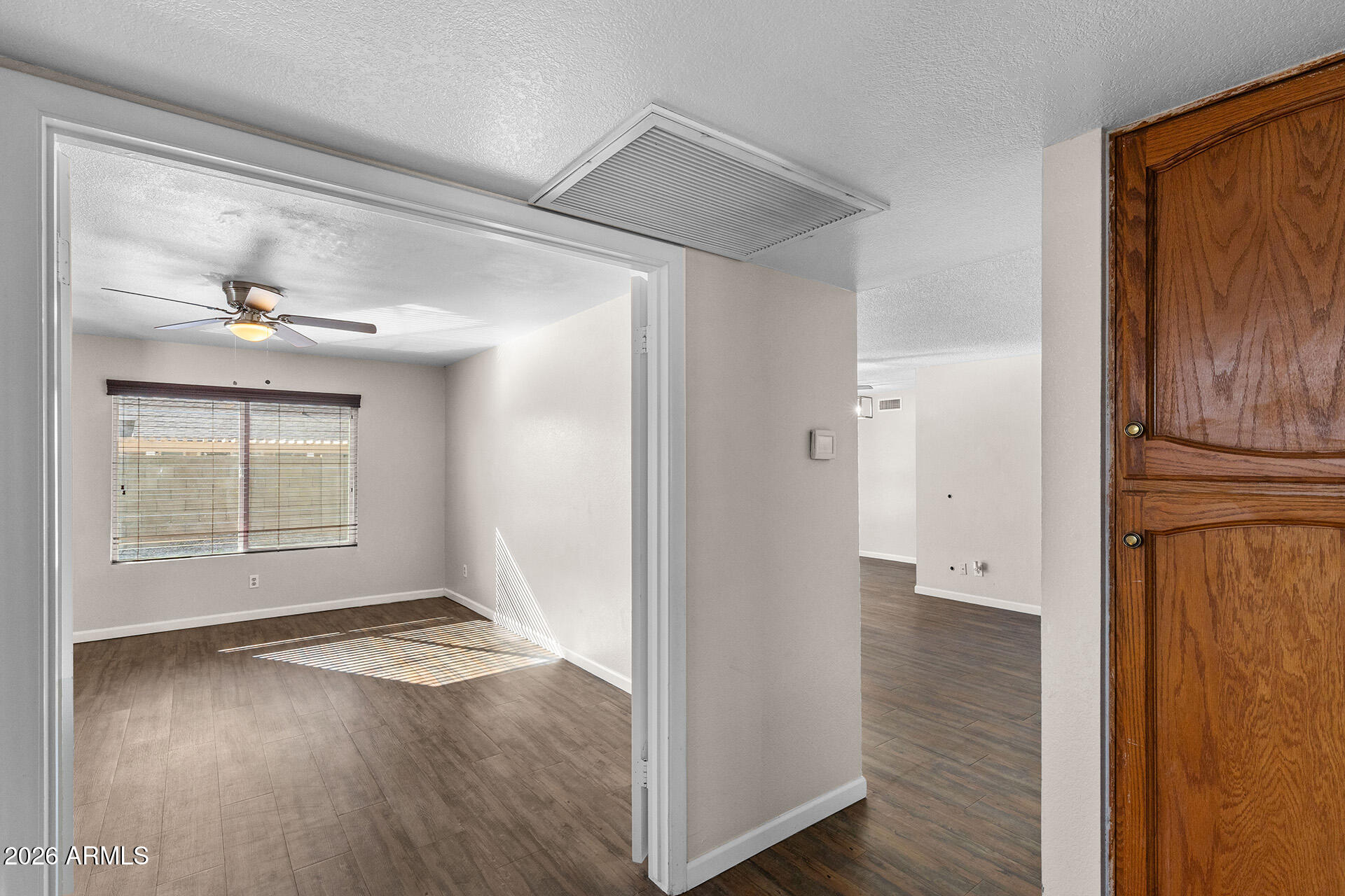 7267 West Charter Oak Road Peoria, AZ 85381 - Photo 25 of 45 an empty room with wooden floor cabinet and windows
