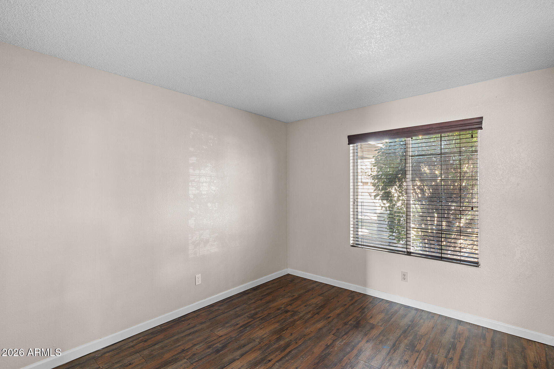 7267 West Charter Oak Road Peoria, AZ 85381 - Photo 27 of 45 an empty room with wooden floor and windows