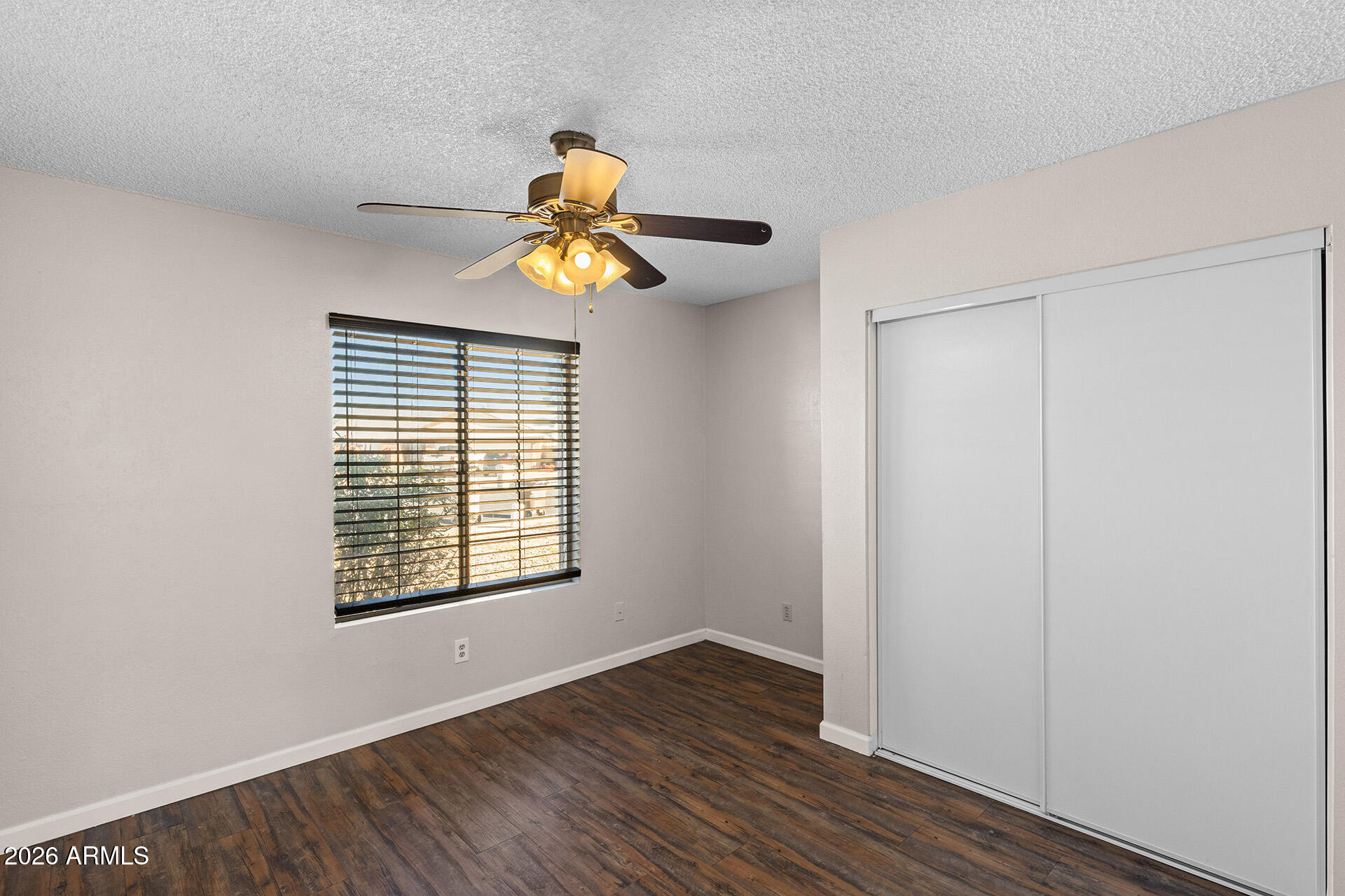 7267 West Charter Oak Road Peoria, AZ 85381 - Photo 29 of 45 a view of an empty room with wooden floor and a window