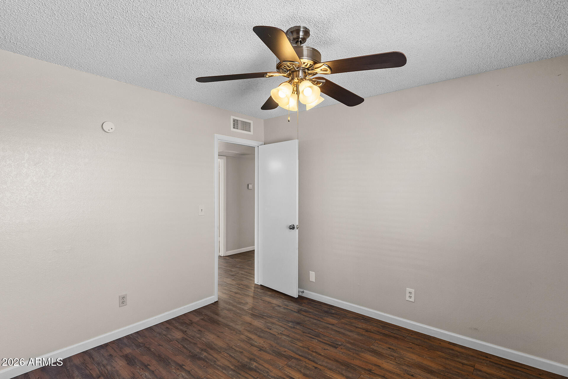 7267 West Charter Oak Road Peoria, AZ 85381 - Photo 30 of 45 a view of an empty room with wooden floor