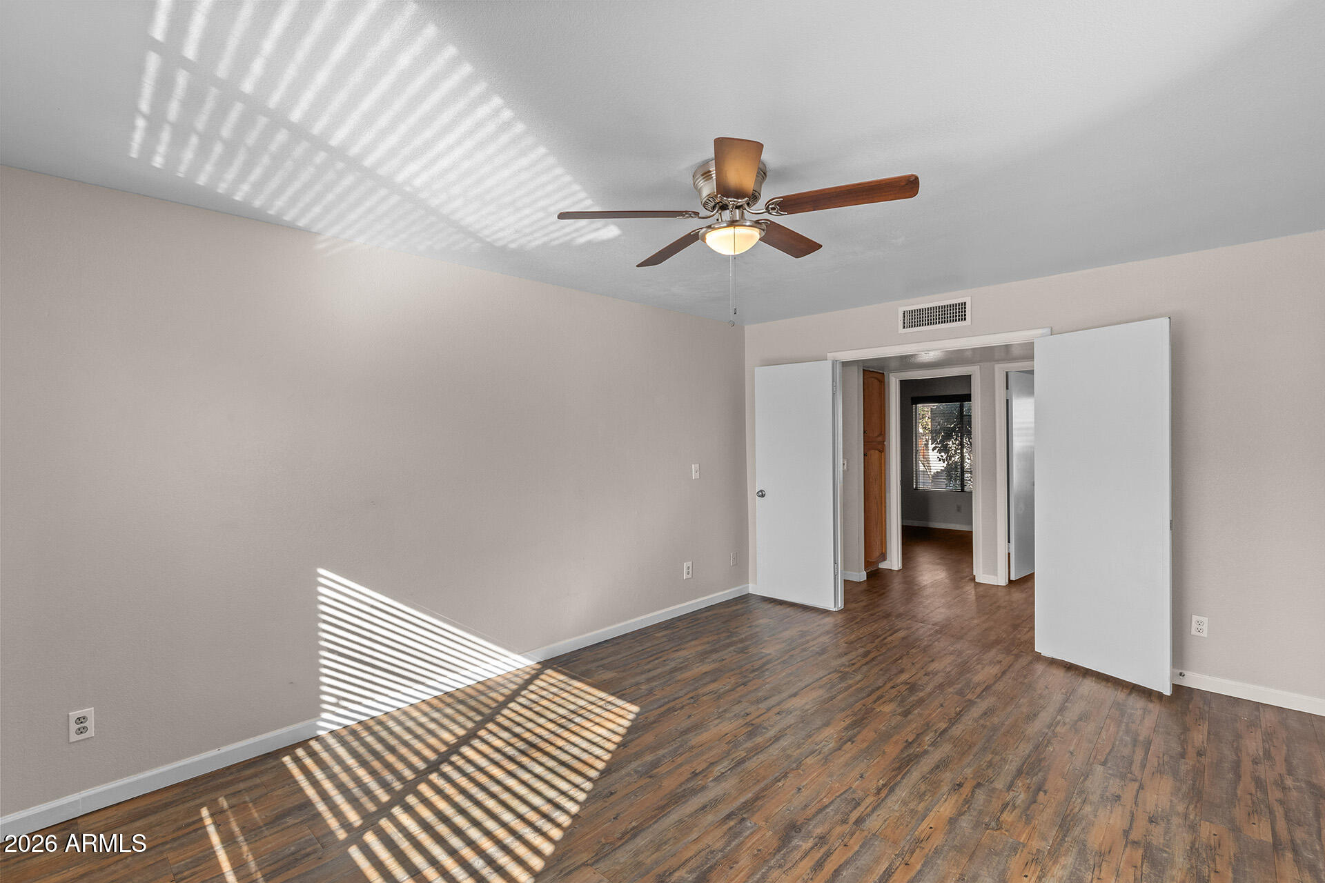 7267 West Charter Oak Road Peoria, AZ 85381 - Photo 33 of 45 a view of a livingroom with wooden floor and a ceiling fan