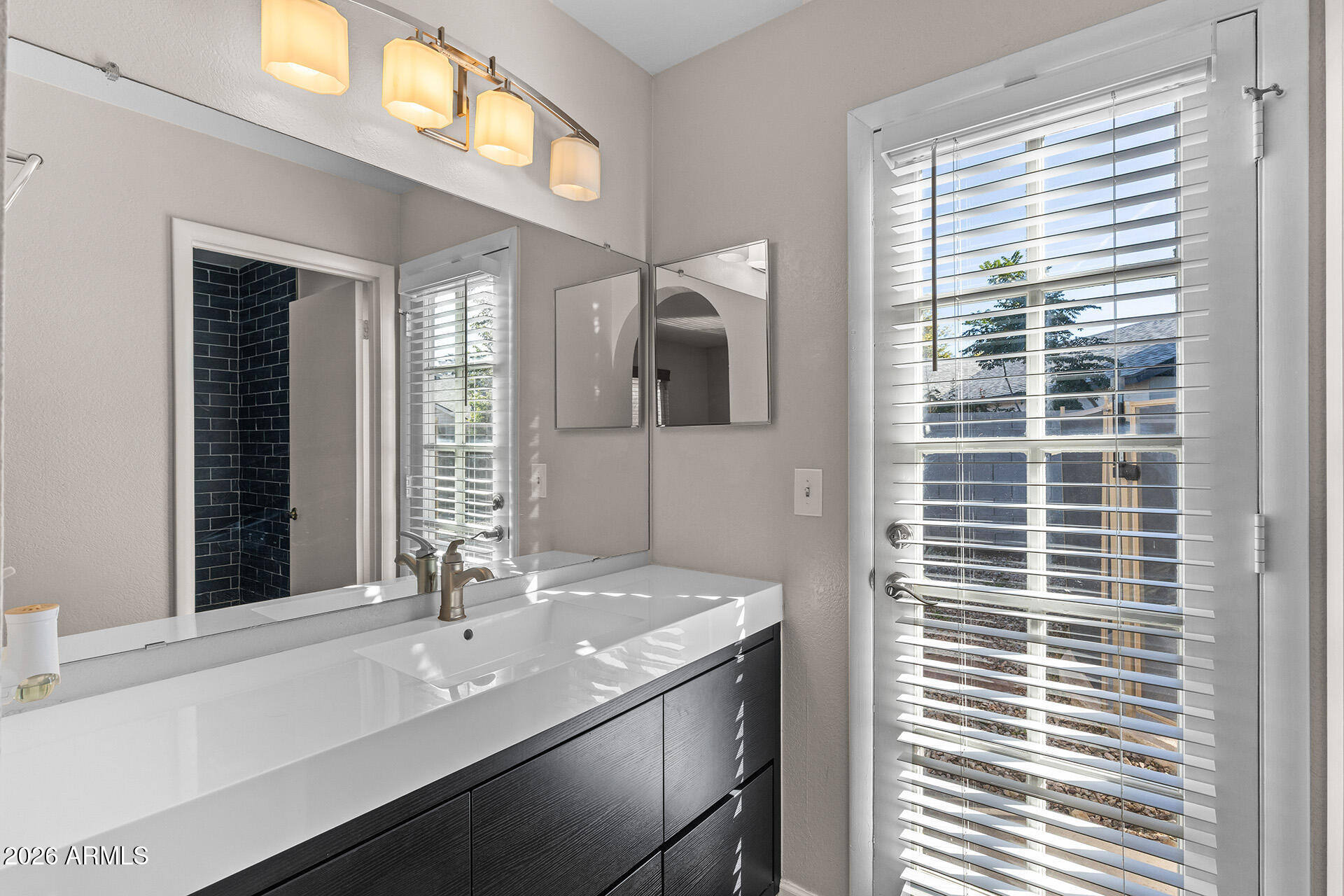 7267 West Charter Oak Road Peoria, AZ 85381 - Photo 35 of 45 a bathroom with a sink and a mirror