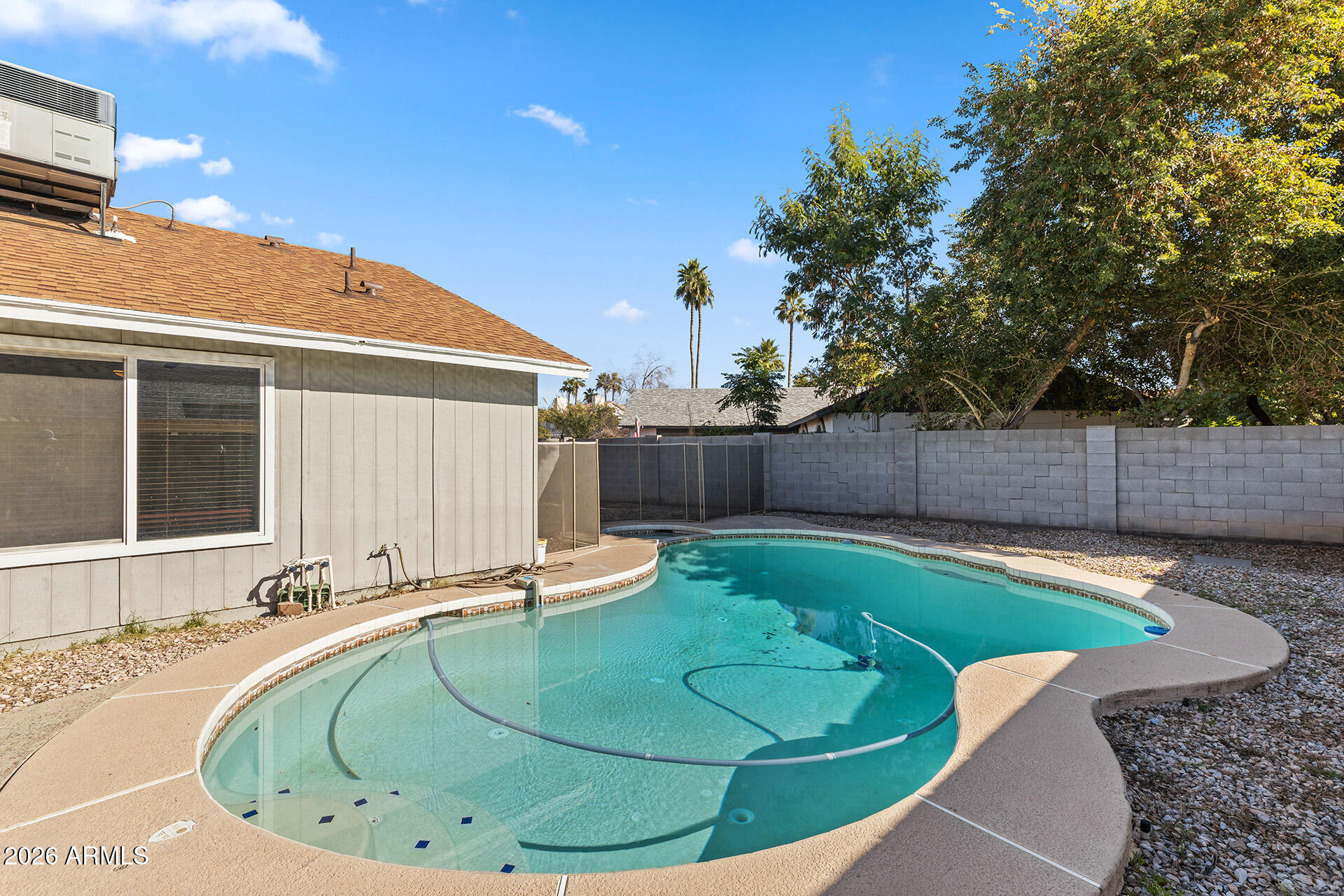 7267 West Charter Oak Road Peoria, AZ 85381 - Photo 43 of 45 a view of a backyard with a tub and wooden fence