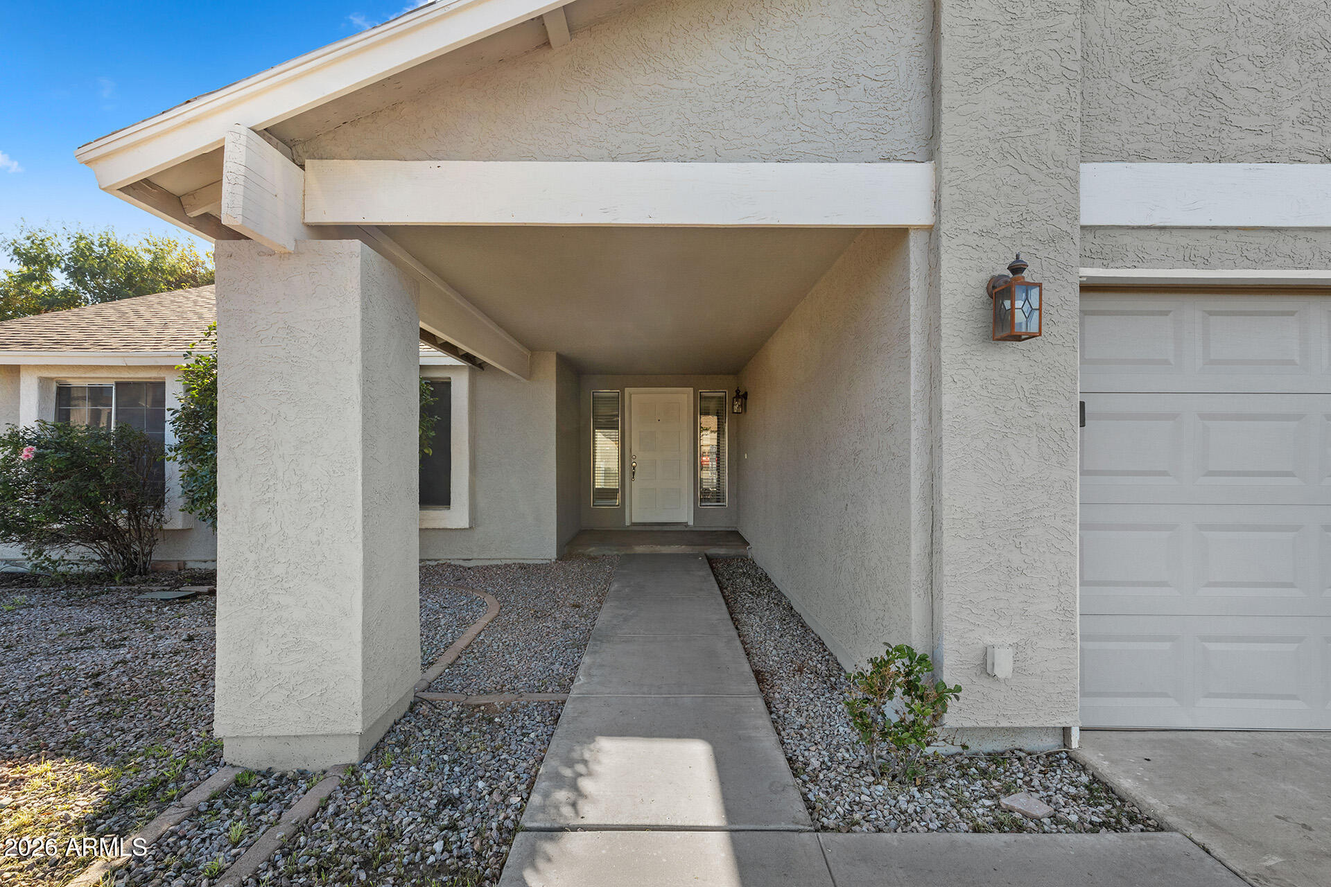 7267 West Charter Oak Road Peoria, AZ 85381 - Photo 9 of 45 a view of a pathway besides a house