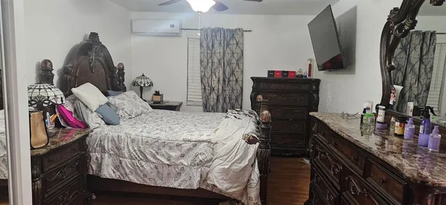 a bedroom with a bed and a dresser