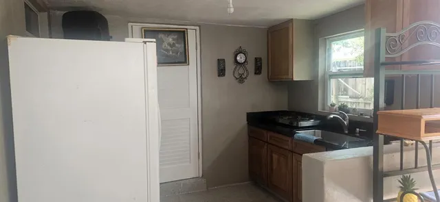 a kitchen with a refrigerator and a stove