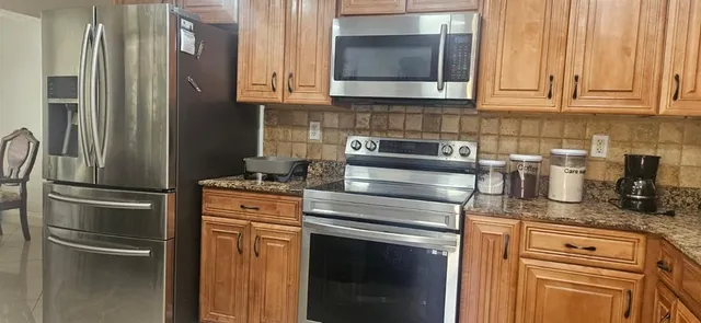 a kitchen with appliances cabinets and a counter top space