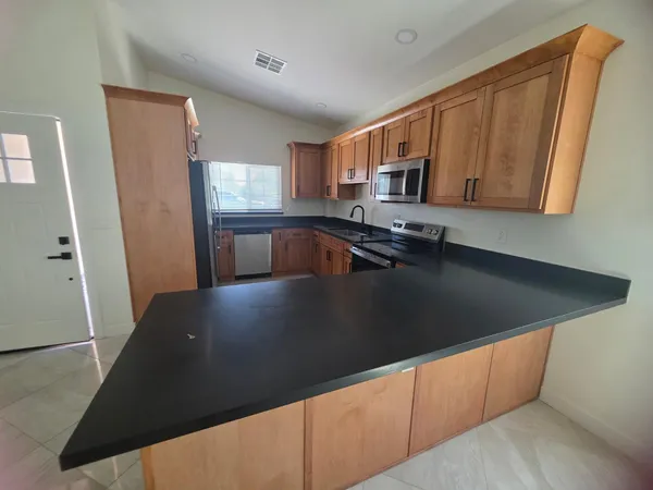 a kitchen with a sink a stove and cabinets