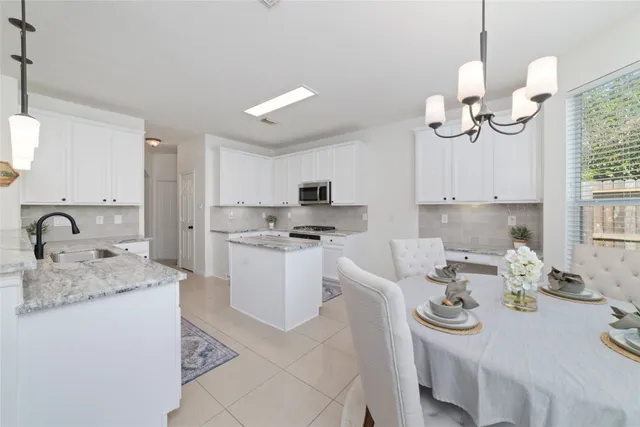a kitchen with sink a microwave and cabinets