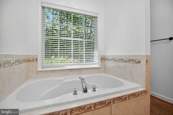 a white bath tub sitting next to a window