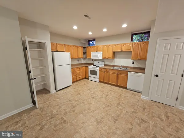 a kitchen with refrigerator and cabinets