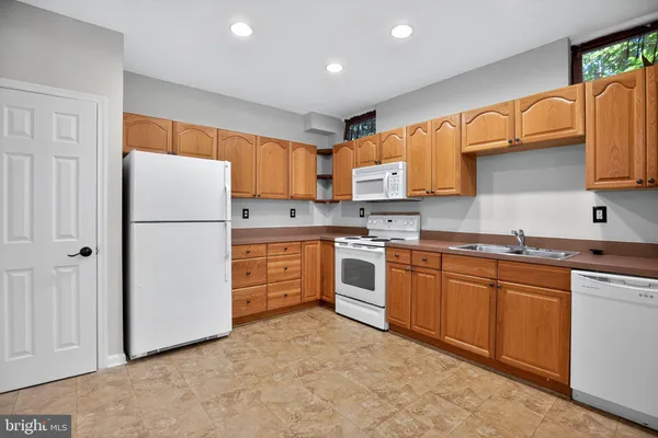 a kitchen with stainless steel appliances granite countertop a refrigerator sink and cabinets