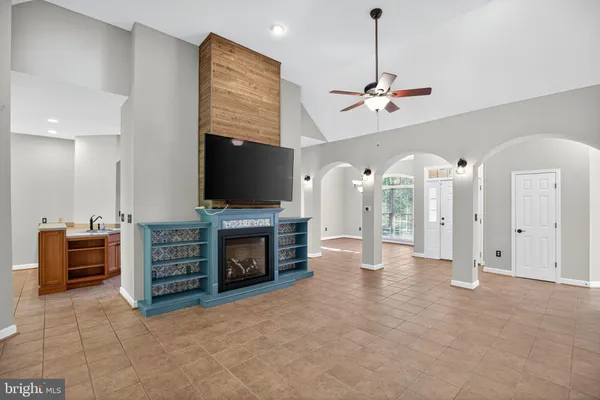 a view of an empty room with furniture and a fireplace