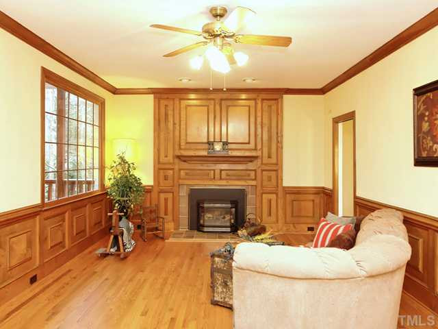 1605 Chatsworth Lane Raleigh, NC 27614 - Photo 2 of 25 Spacious and inviting family room has hardwood floor, raised paneling, crown molding, two huge windows, ceiling fan and gas log fireplace with tile surround and decorative wood mantle! Den/Family/Great Room