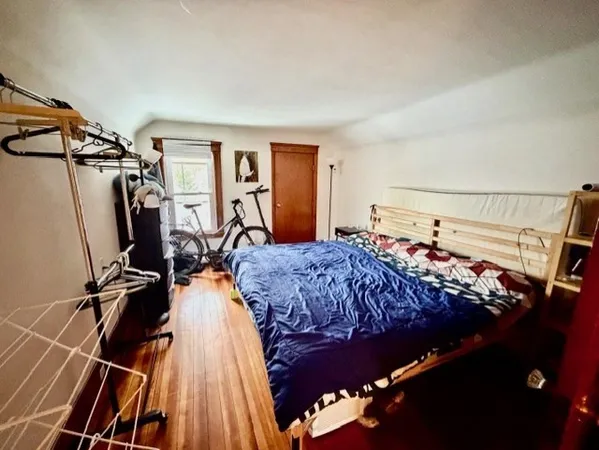 a bed sitting in a bedroom next to a window