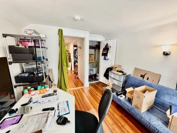 a bedroom with furniture and a flat screen tv