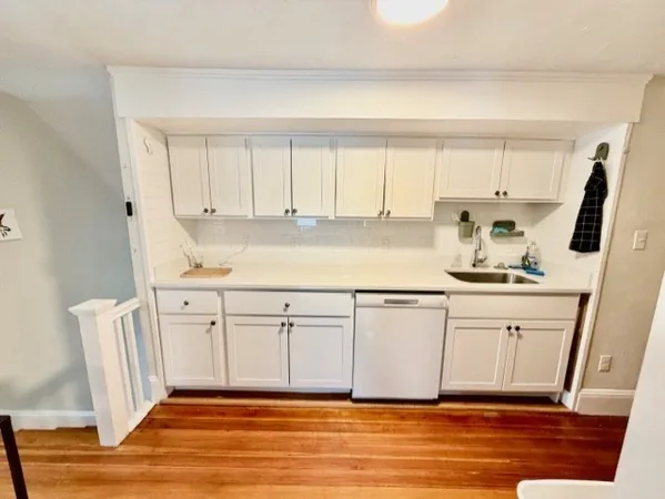 a white kitchen with a sink