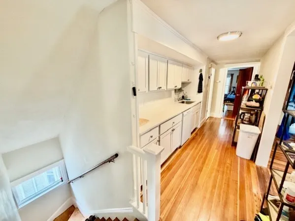 a hall with wooden floor and furniture