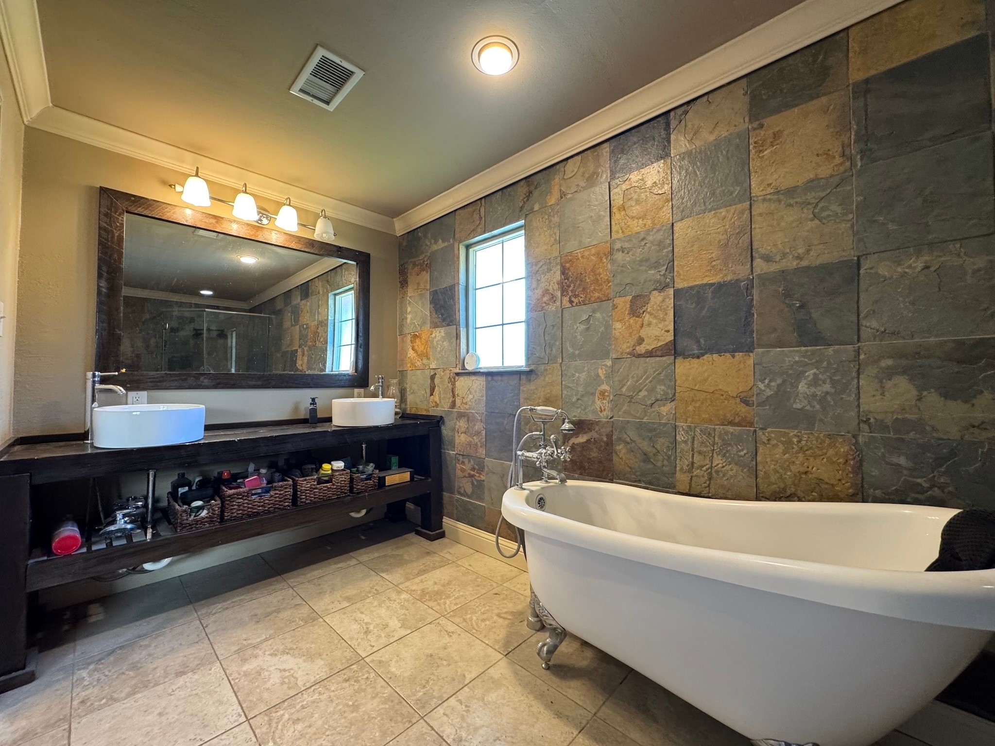 114 Elmwood Street Huntsville, TX 77320 - Photo 12 of 18 a bathroom with a bathtub and a double vanity sink